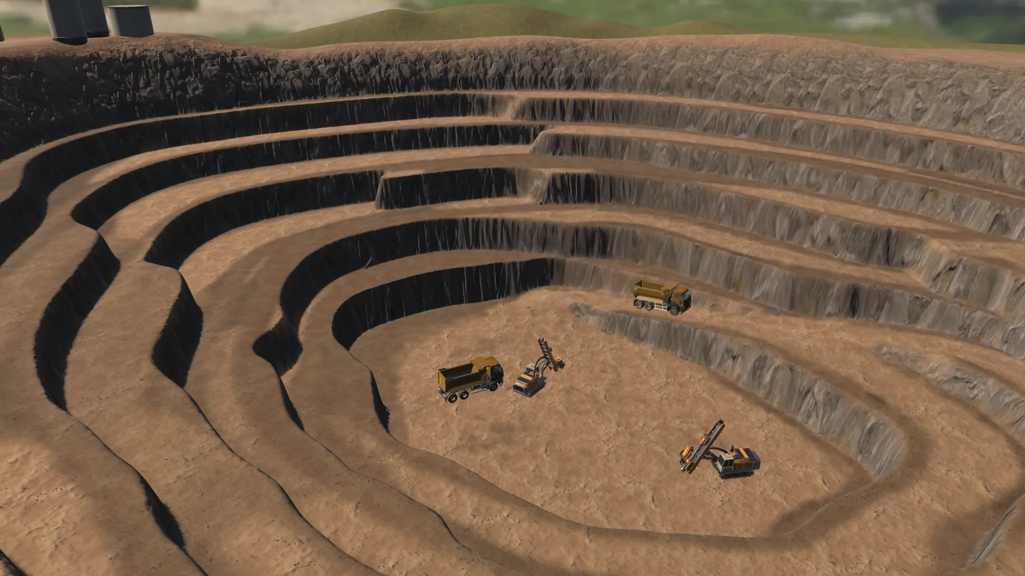 Elevated view of the open pit showing concentric benches, ramps and mining equipment