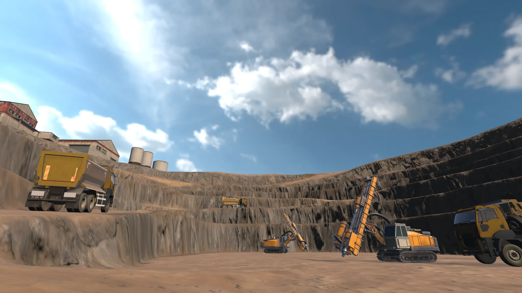 View from the floor of the open pit with heavy mining vehicles against high stepped rock walls