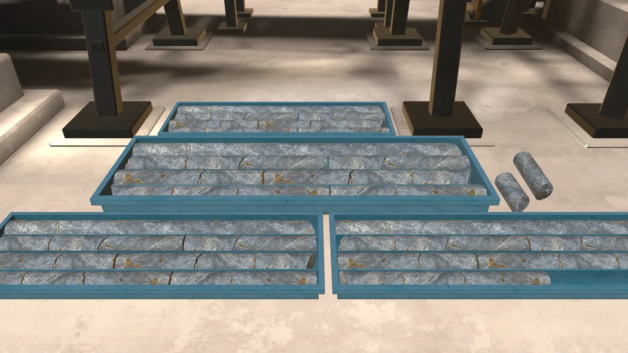 Multiple blue geological core sample boxes set on the factory floor